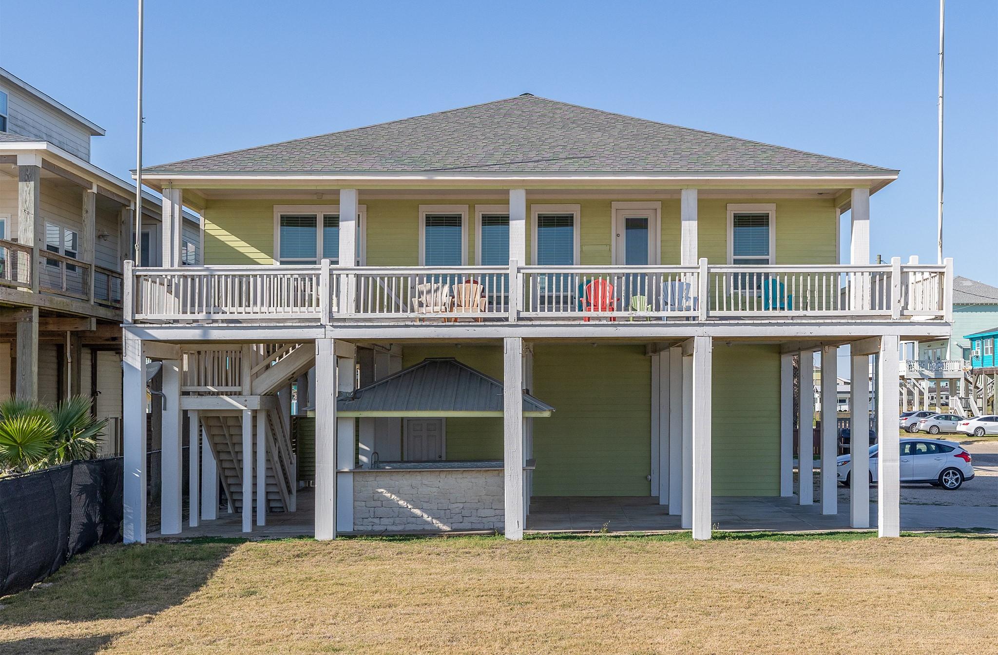 Image 3: This elevated beach house features a spacious wrap