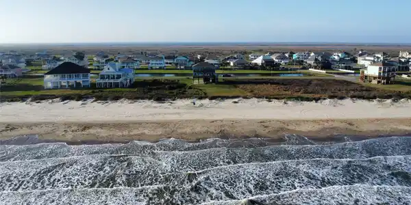 Image 3: Aerial view from over the Gulf back to the house