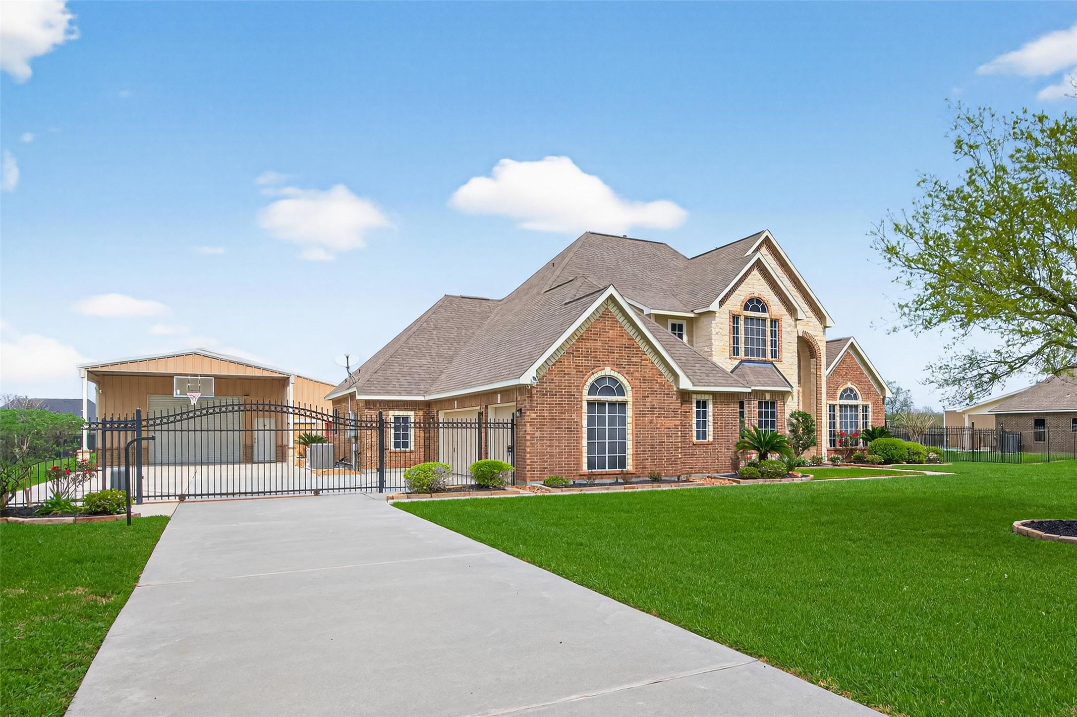 Image 2: behind the electric gate is a 3 car garage plus sp
