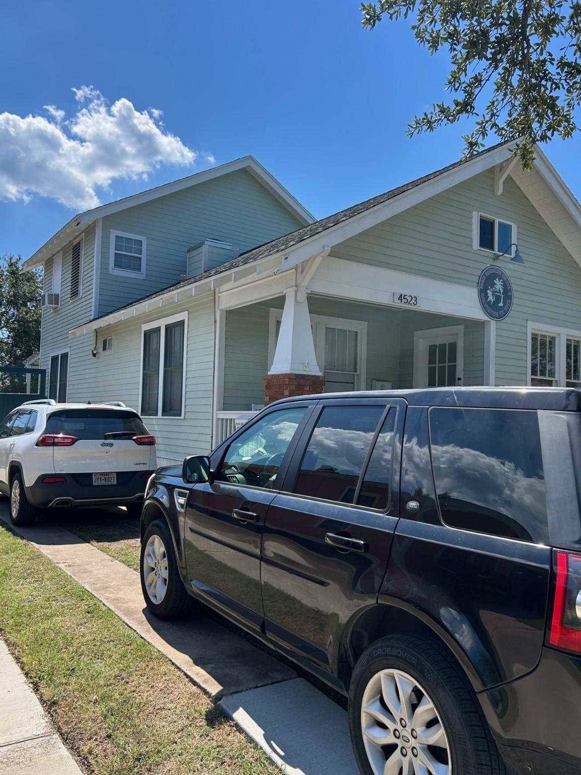 Image 3: East side of the house with full driveway from the