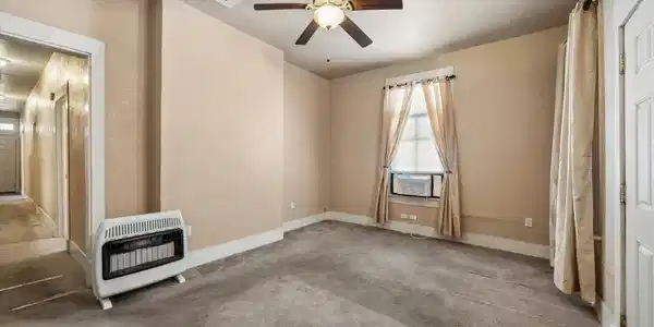 Image 3: Cozy room with neutral tones, featuring a ceiling