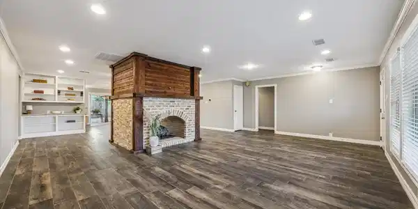 Image 2: Expansive living area with a striking central fire