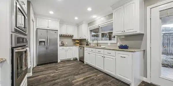 Image 4: The spacious kitchen boasts sleek stainless steel