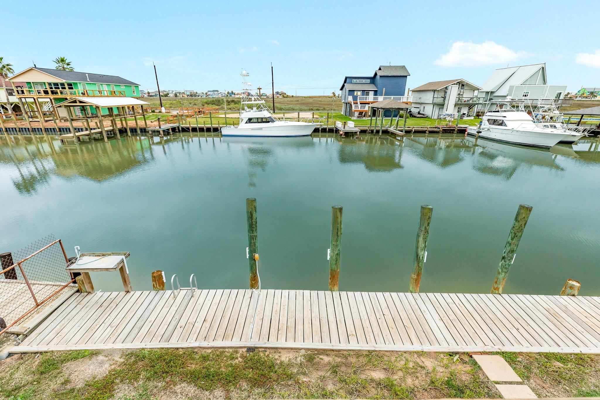 Image 2: A wide deck view showcasing the calm canal and nea