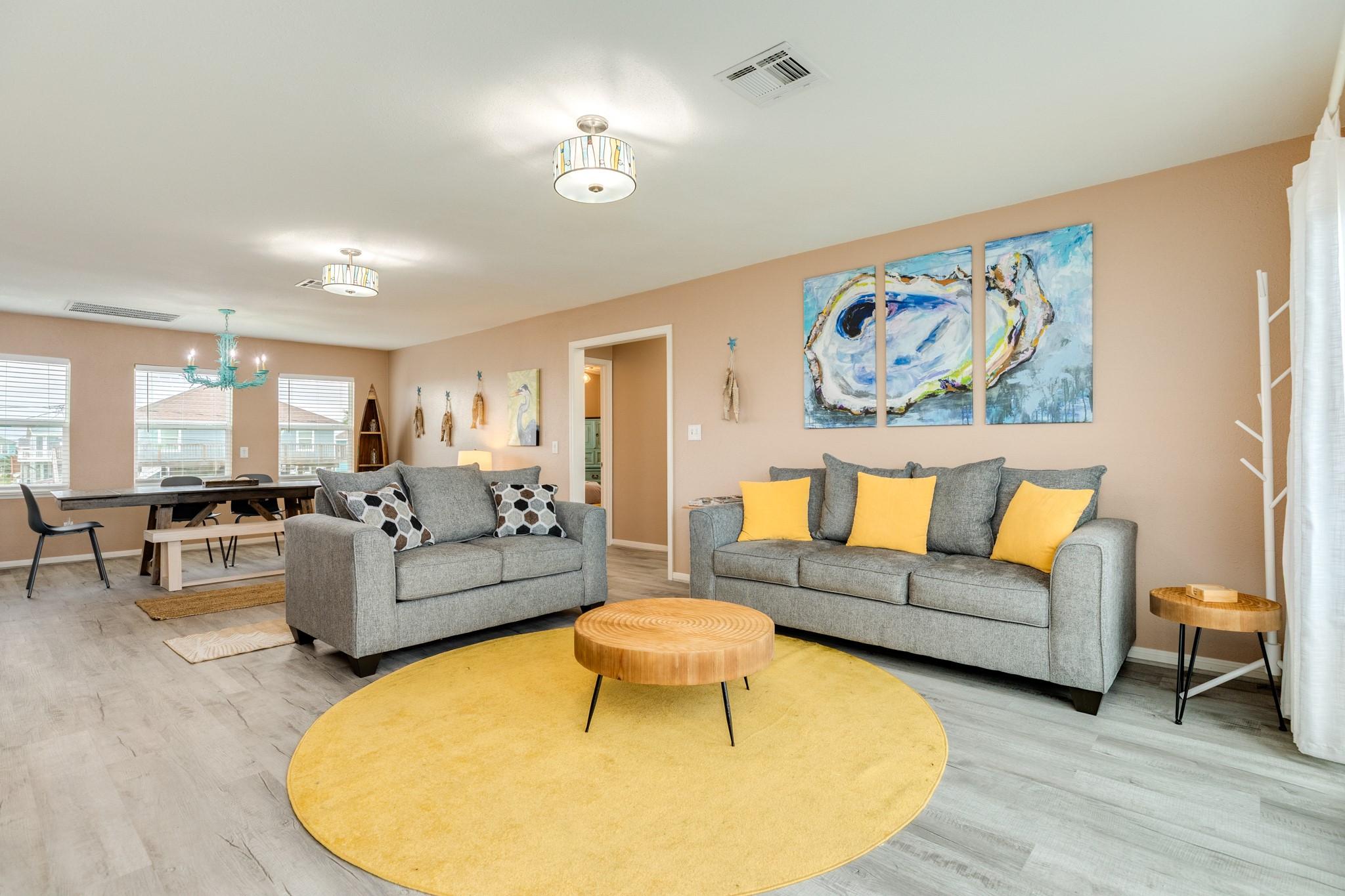 Image 4: This spacious living area features coastal-inspire