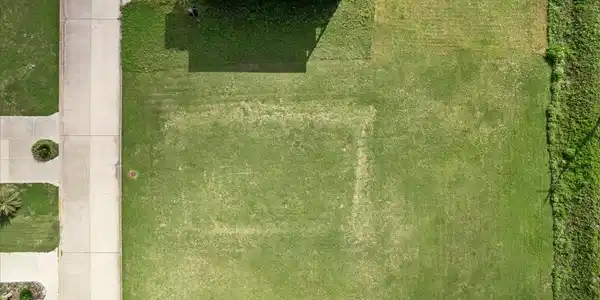 Image 3: Cleared and level from above, the lot offers a cle