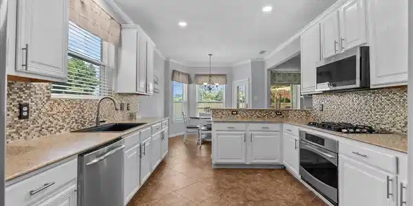 Image 3: Bright and airy kitchen with white cabinetry, upda