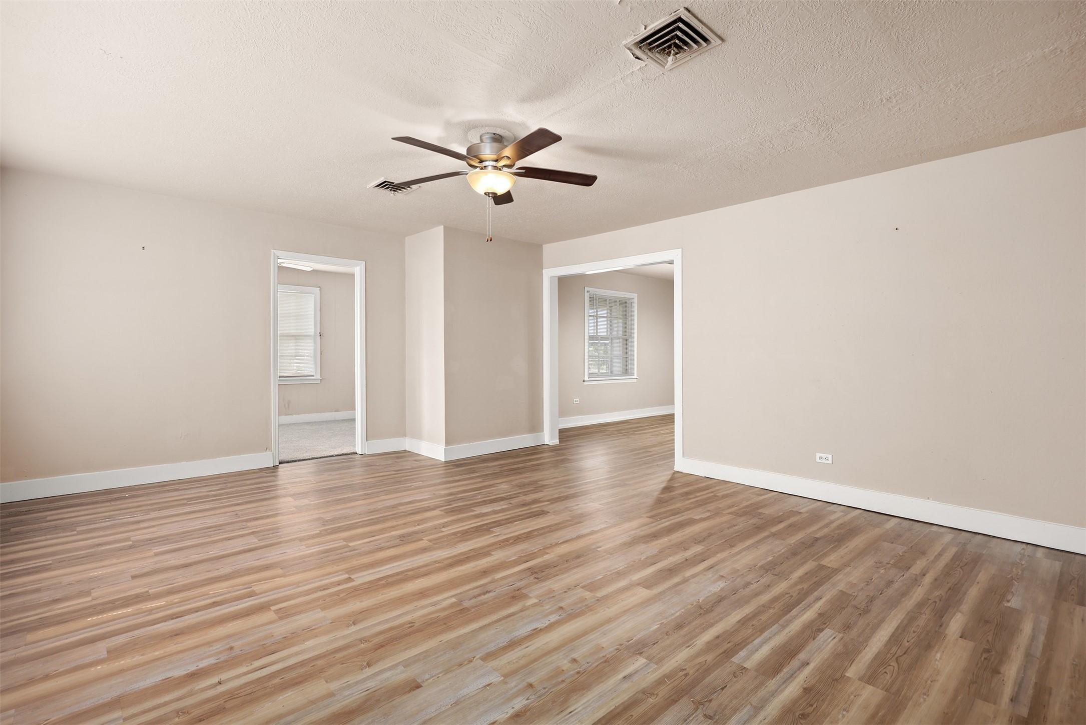 Image 4: Living room with view into bedroom 3 and dining ro