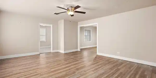 Image 4: Living room with view into bedroom 3 and dining ro
