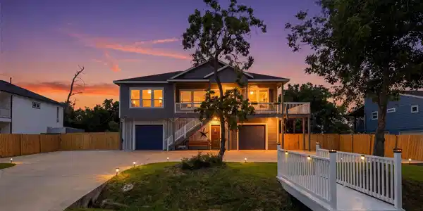 Image 2: Inviting bridge entrance leads to a charming home,