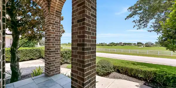 Image 3: This East-facing covered porch enjoys vistas of th