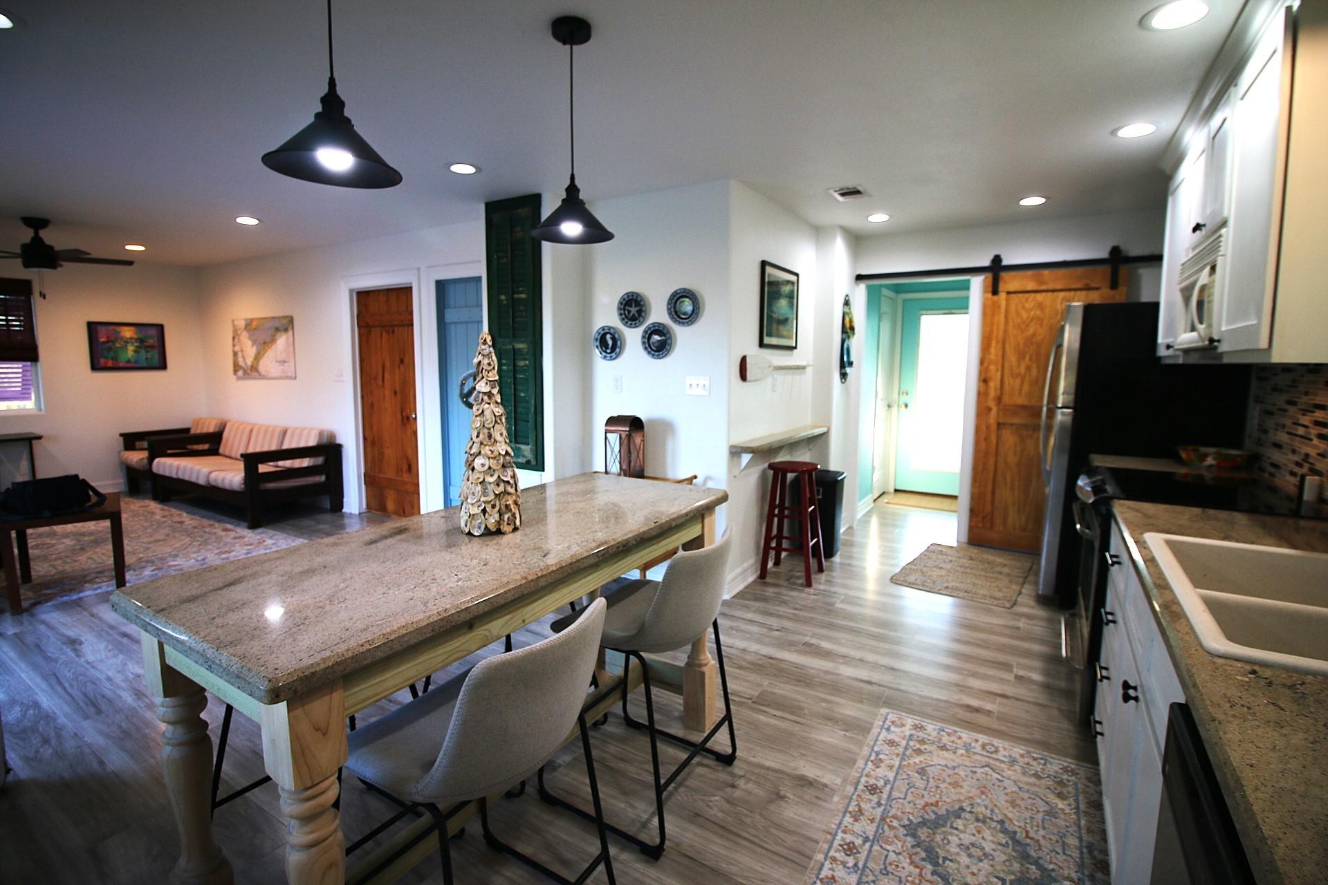 Image 3: This cozy open-concept home features a modern kitc