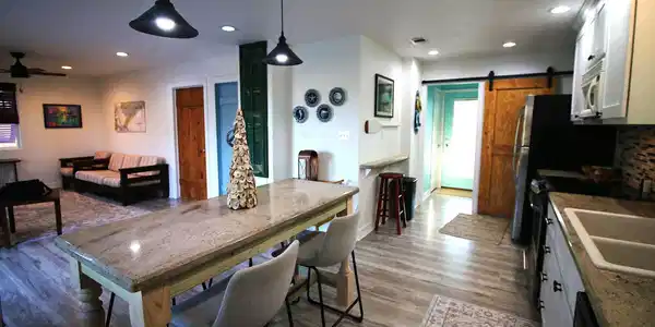 Image 3: This cozy open-concept home features a modern kitc
