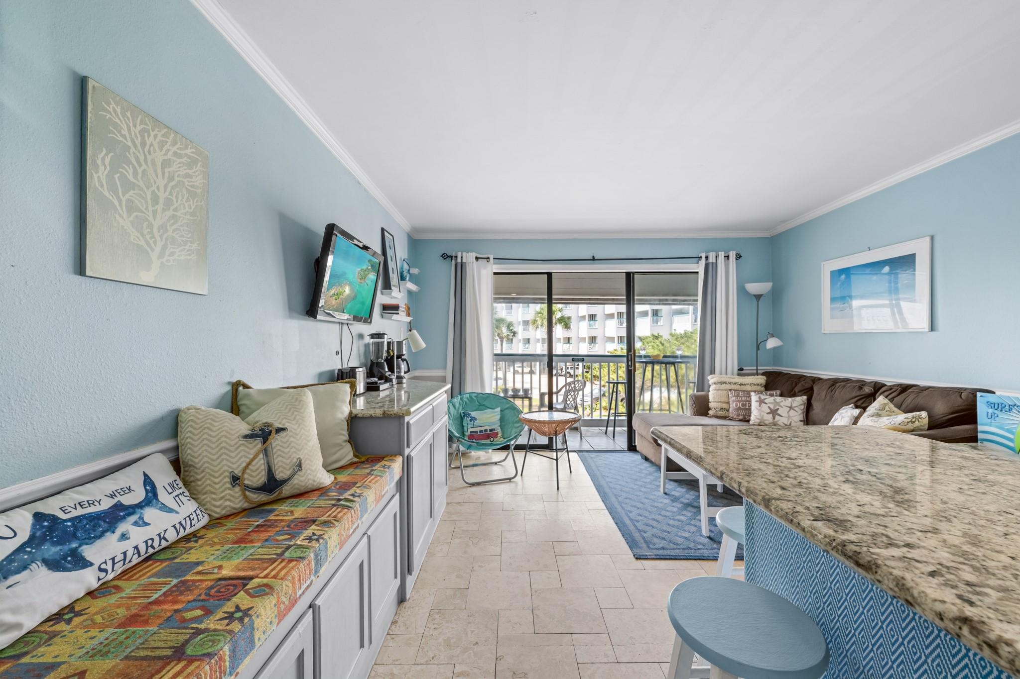 Image 3: Bright, open living area with coastal-inspired d&eacute;c