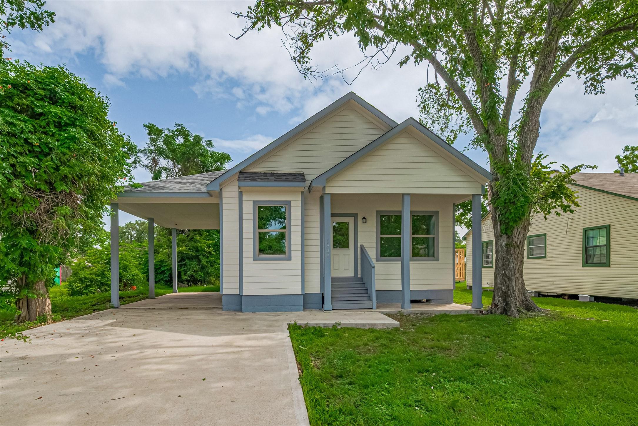 Image 1: Charming home with a convenient covered carport.