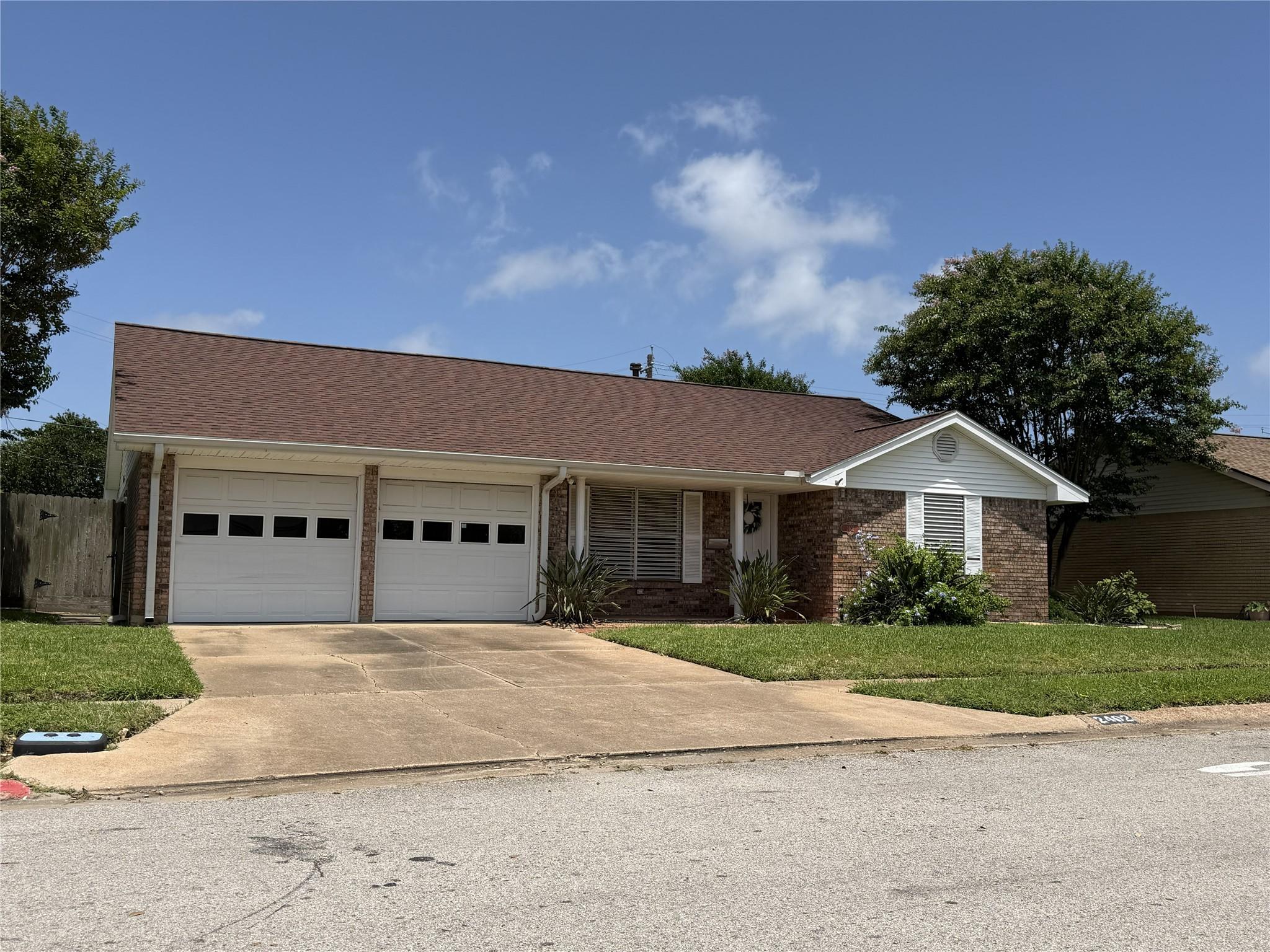 Image 1: This is a charming single-story brick home with a