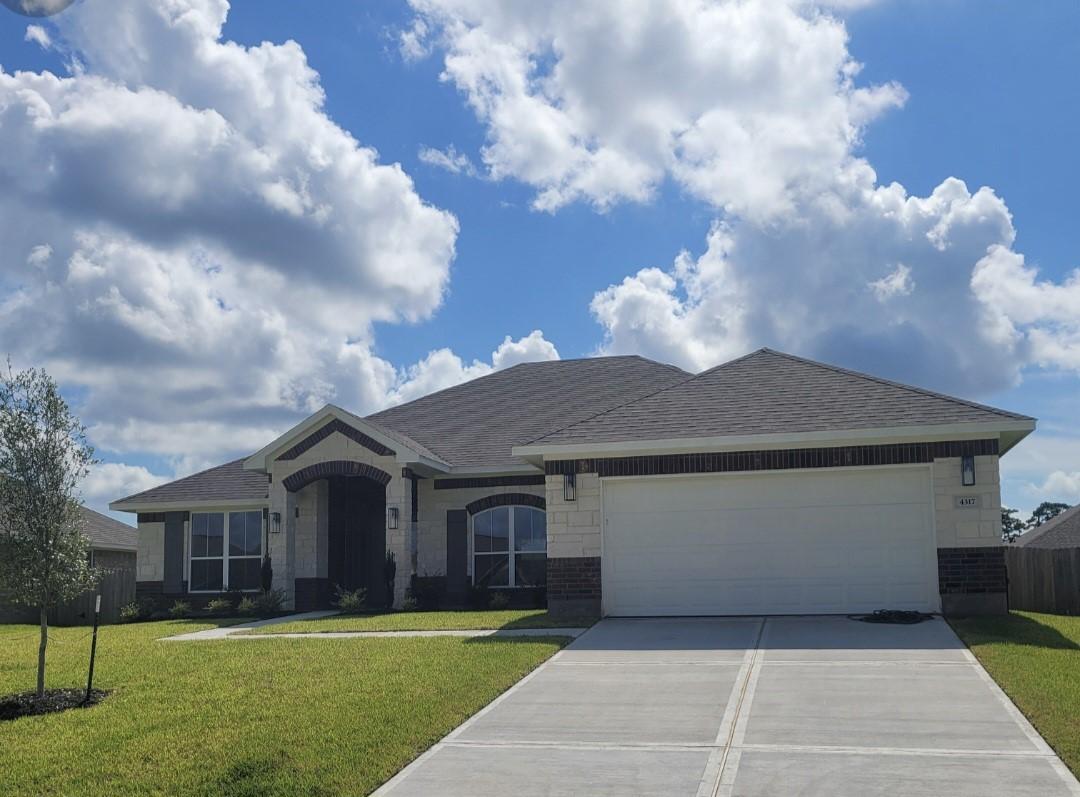 Image 1: This is a modern, single-story home with a two-car