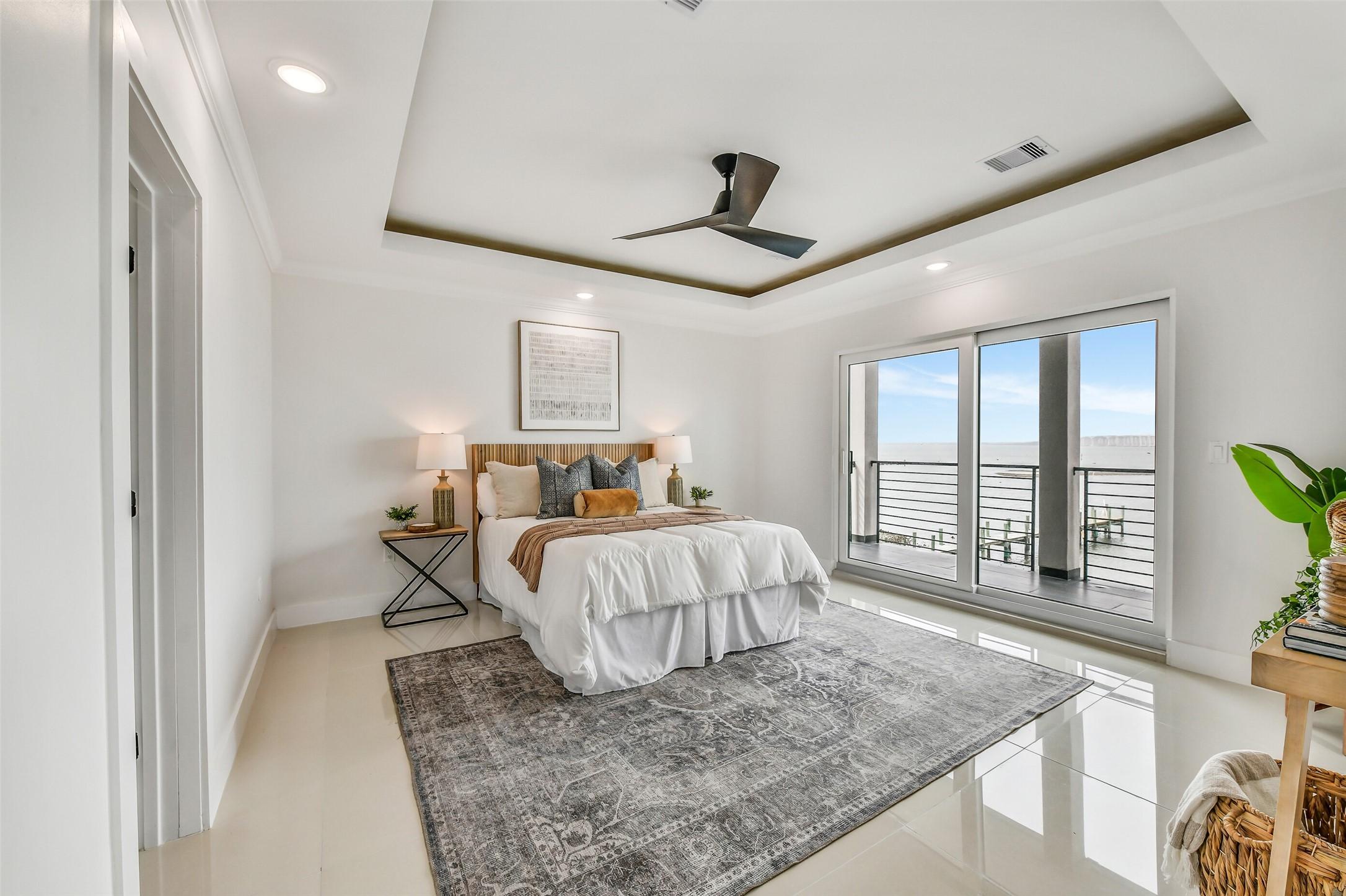 Image 3: The first-floor primary suite offers privacy and c