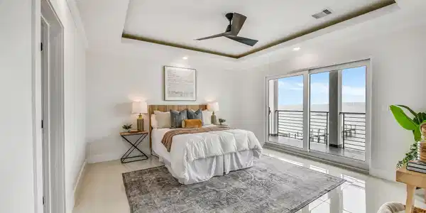 Image 3: The first-floor primary suite offers privacy and c