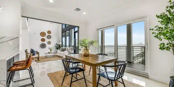 Image 4: Sunlight and water views elevate every gathering.