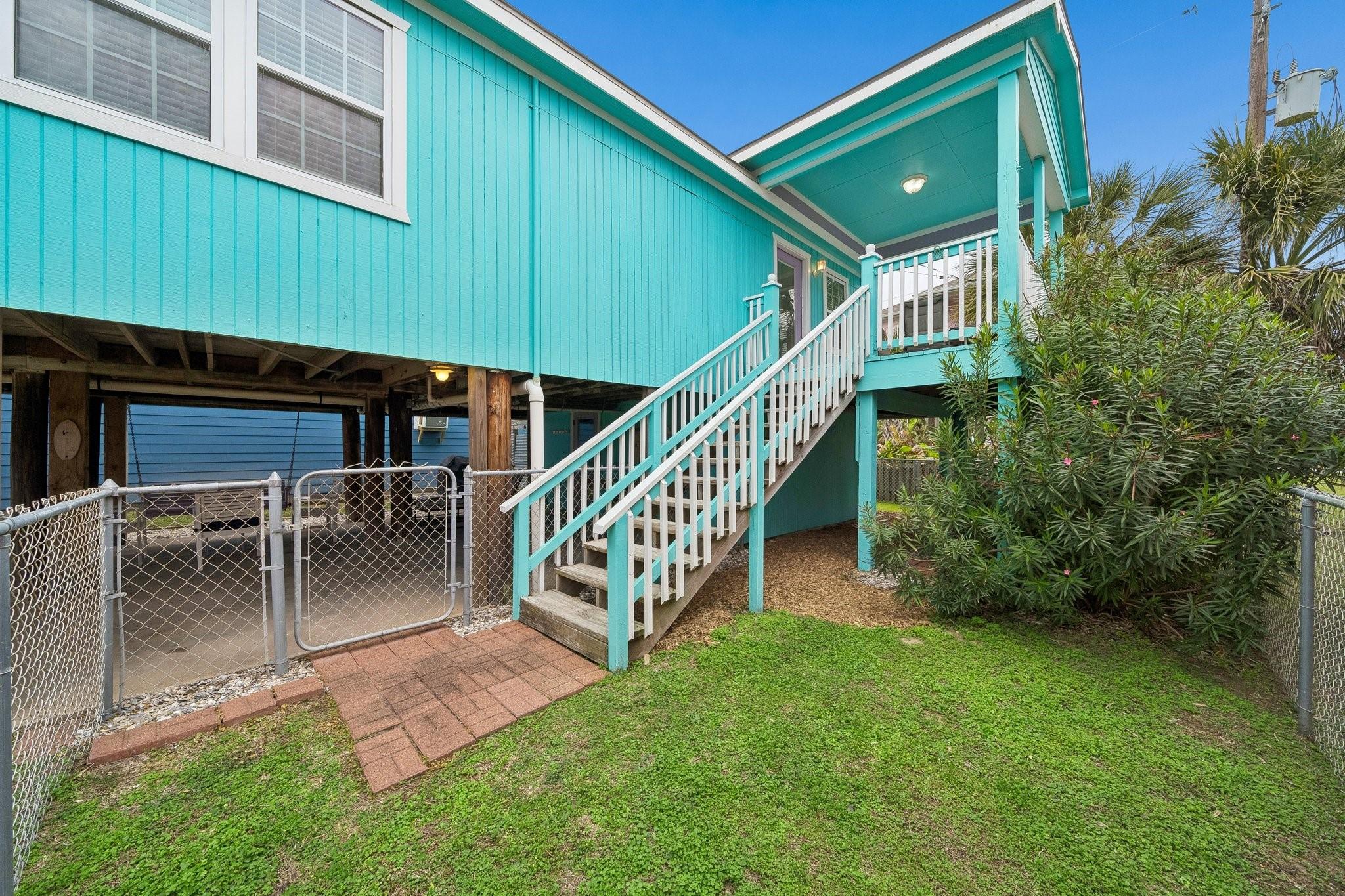 Image 2: Elevated home with exterior staircase leading to t