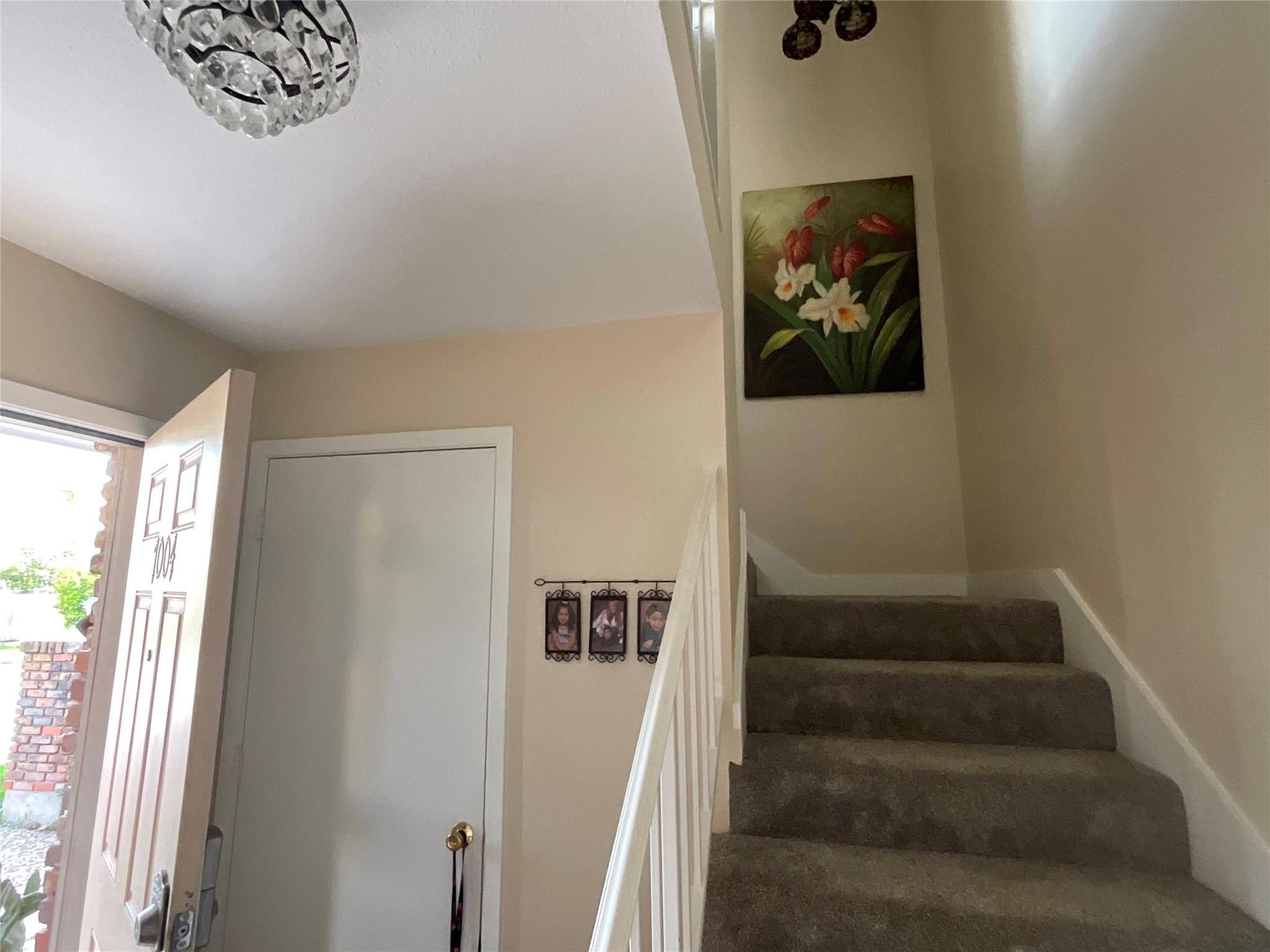 Image 2: Entry has very large under stairwell storage and c