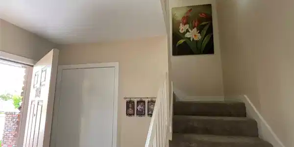Image 2: Entry has very large under stairwell storage and c