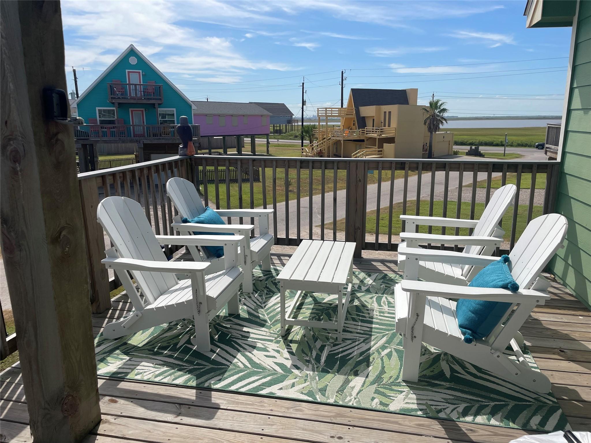 Image 3: Views off the deck are of the bay and beach