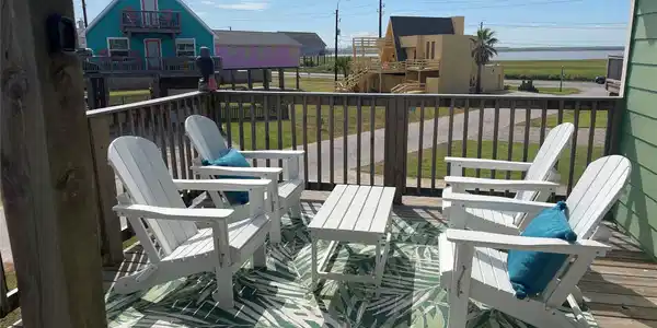 Image 3: Views off the deck are of the bay and beach