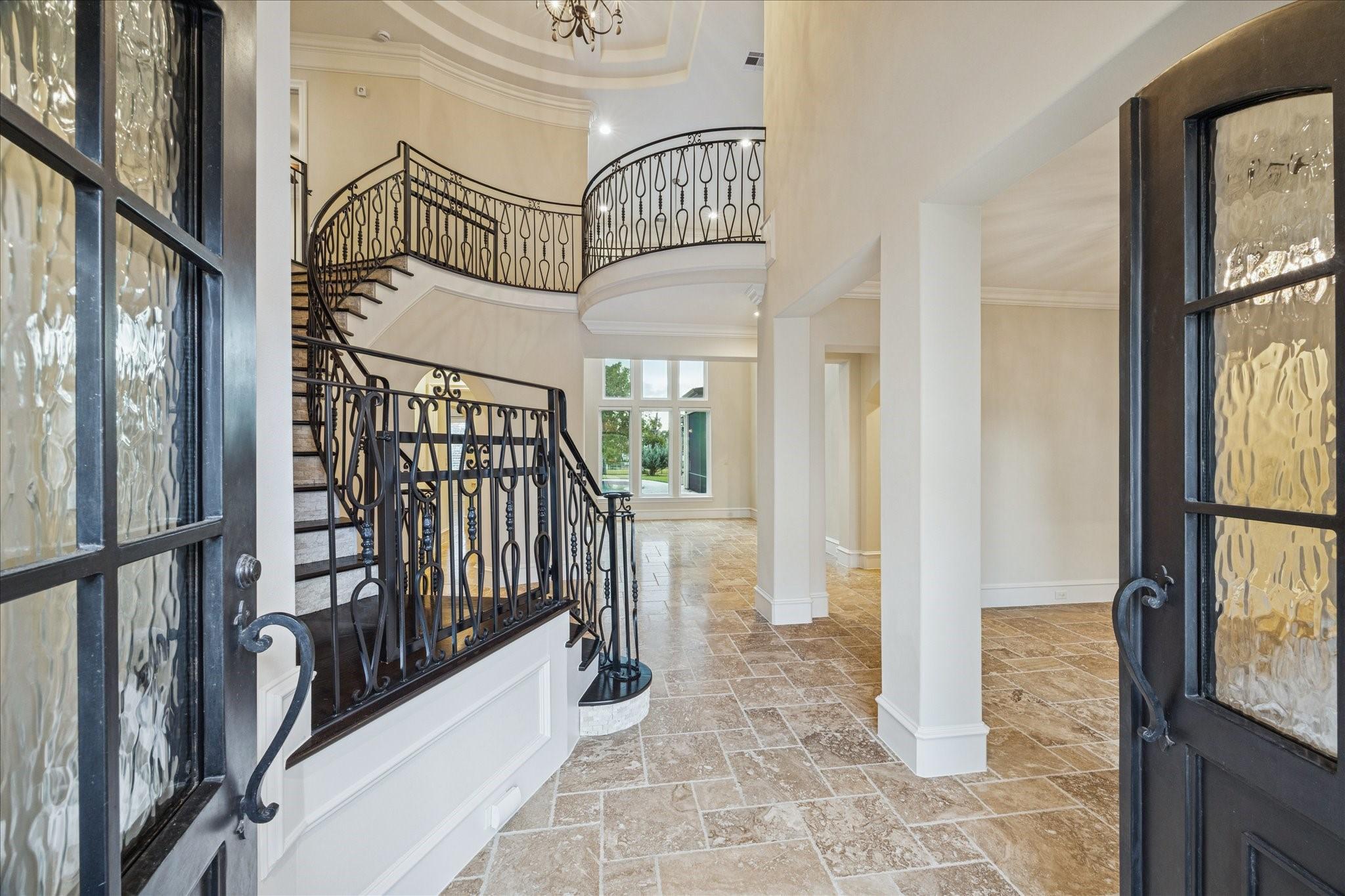 Image 4: This grand entryway features elegant double doors