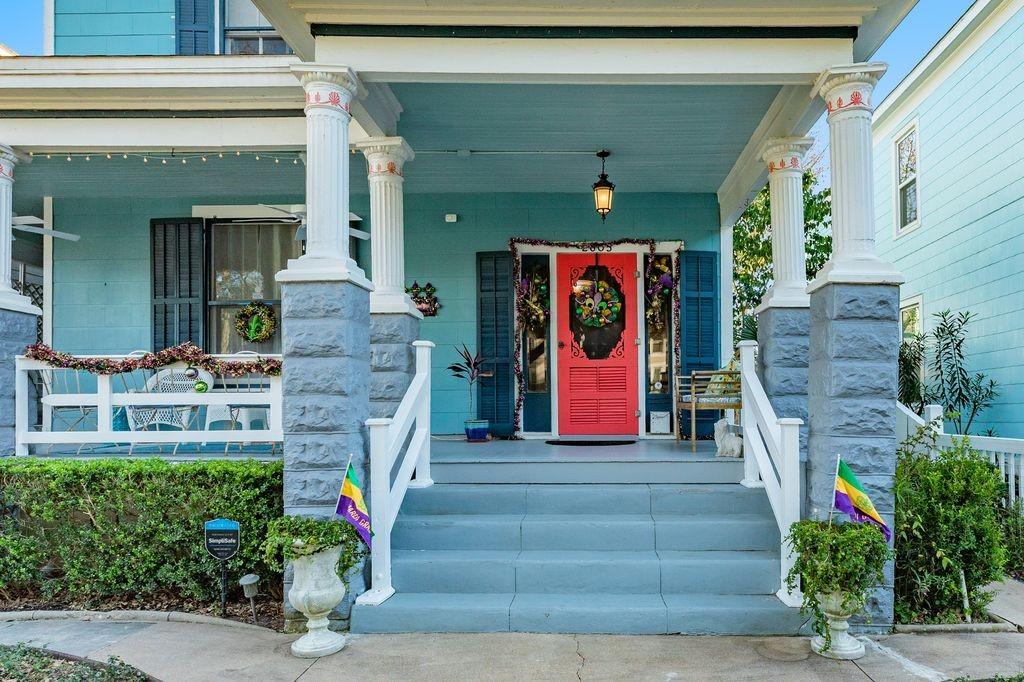 Image 2: Front door with porch facing street lined with his