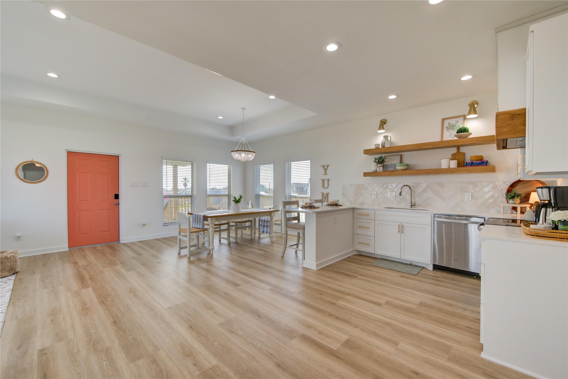 Image 4: Bright open-concept living space filled with natur