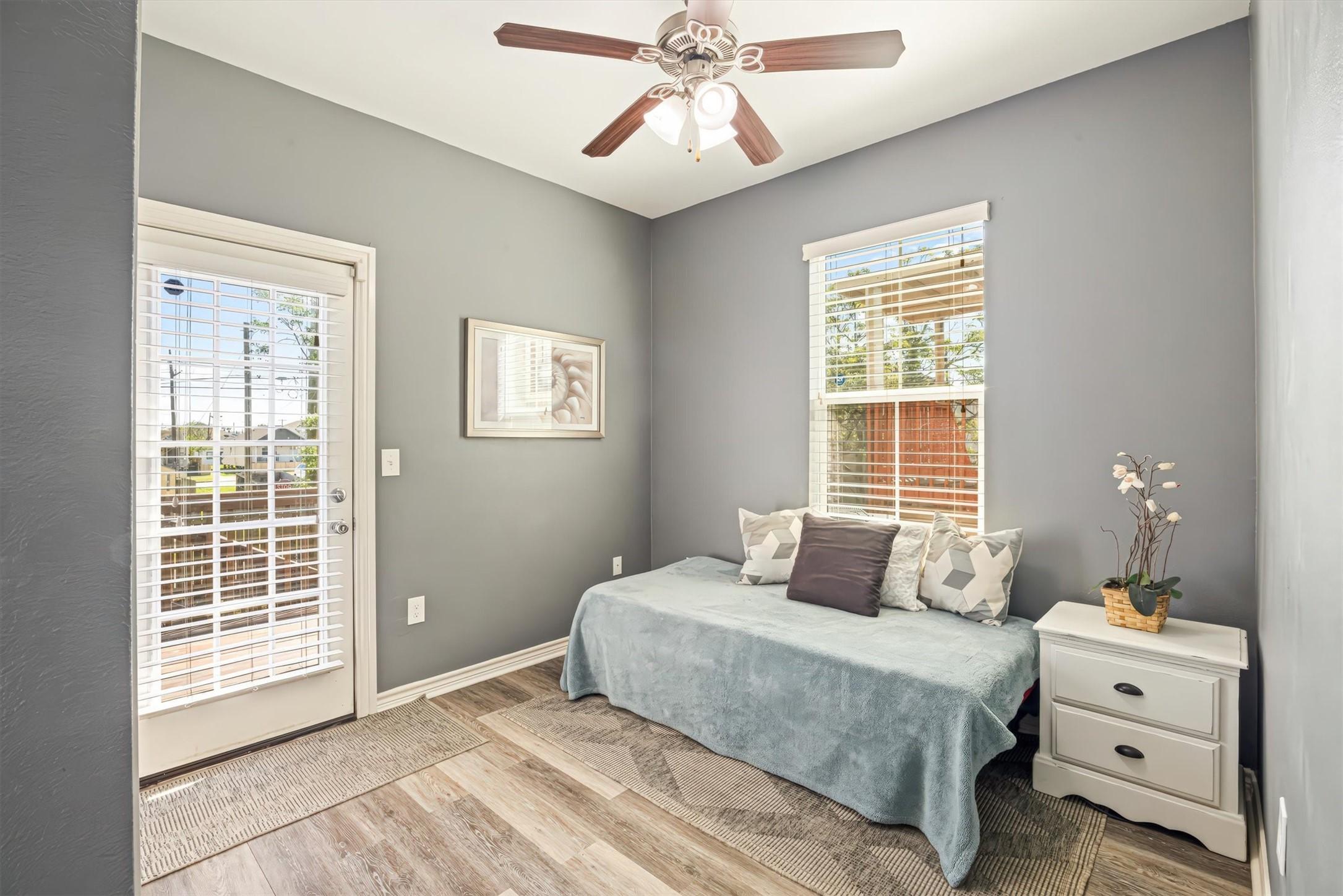 Image 4: This cozy room features gray walls, a ceiling fan,