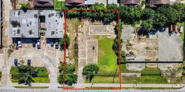 Image 2: The lot is mostly flat with some grassy areas and