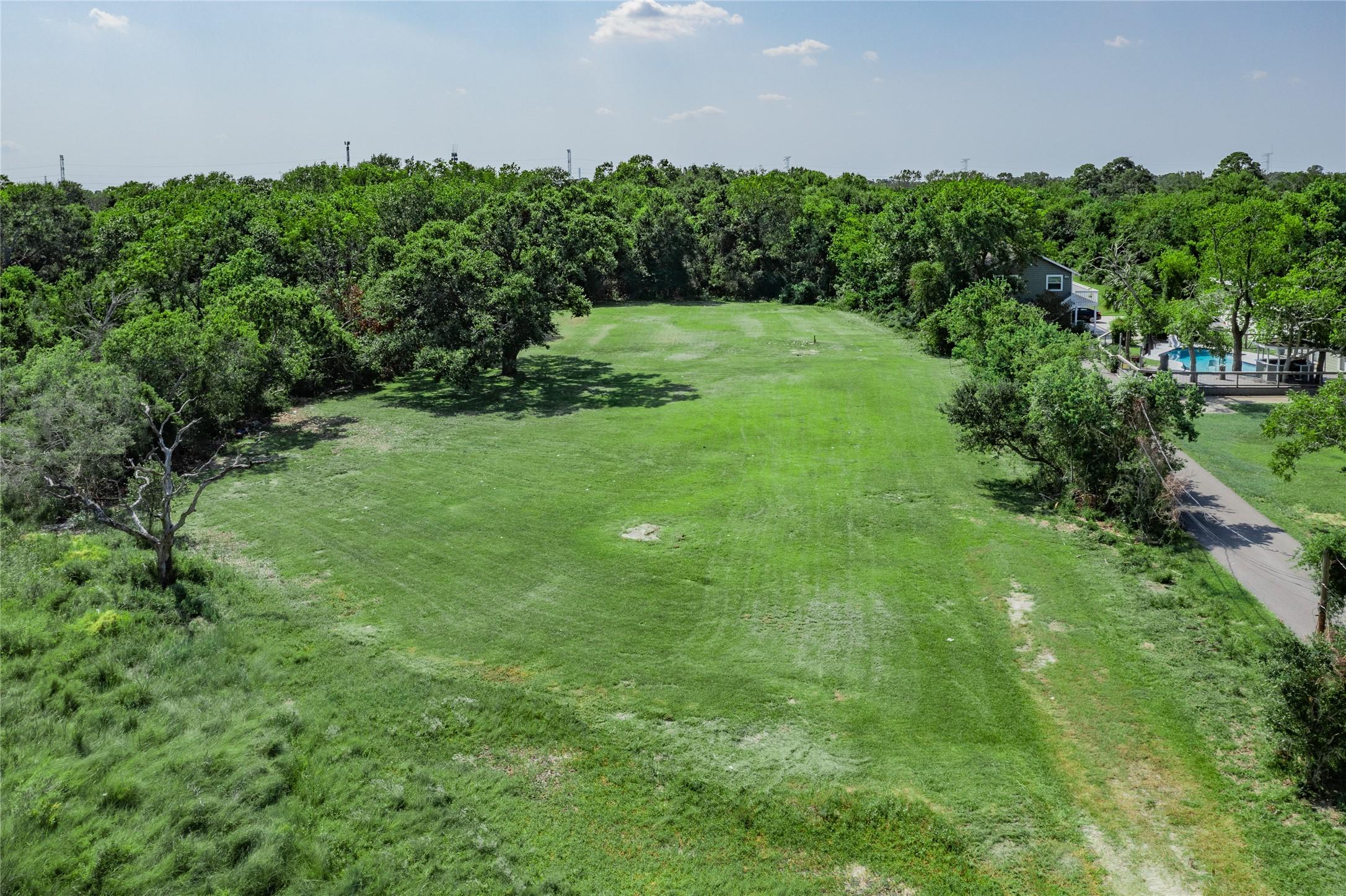 Image 4: This aerial photo showcases a spacious, lush green