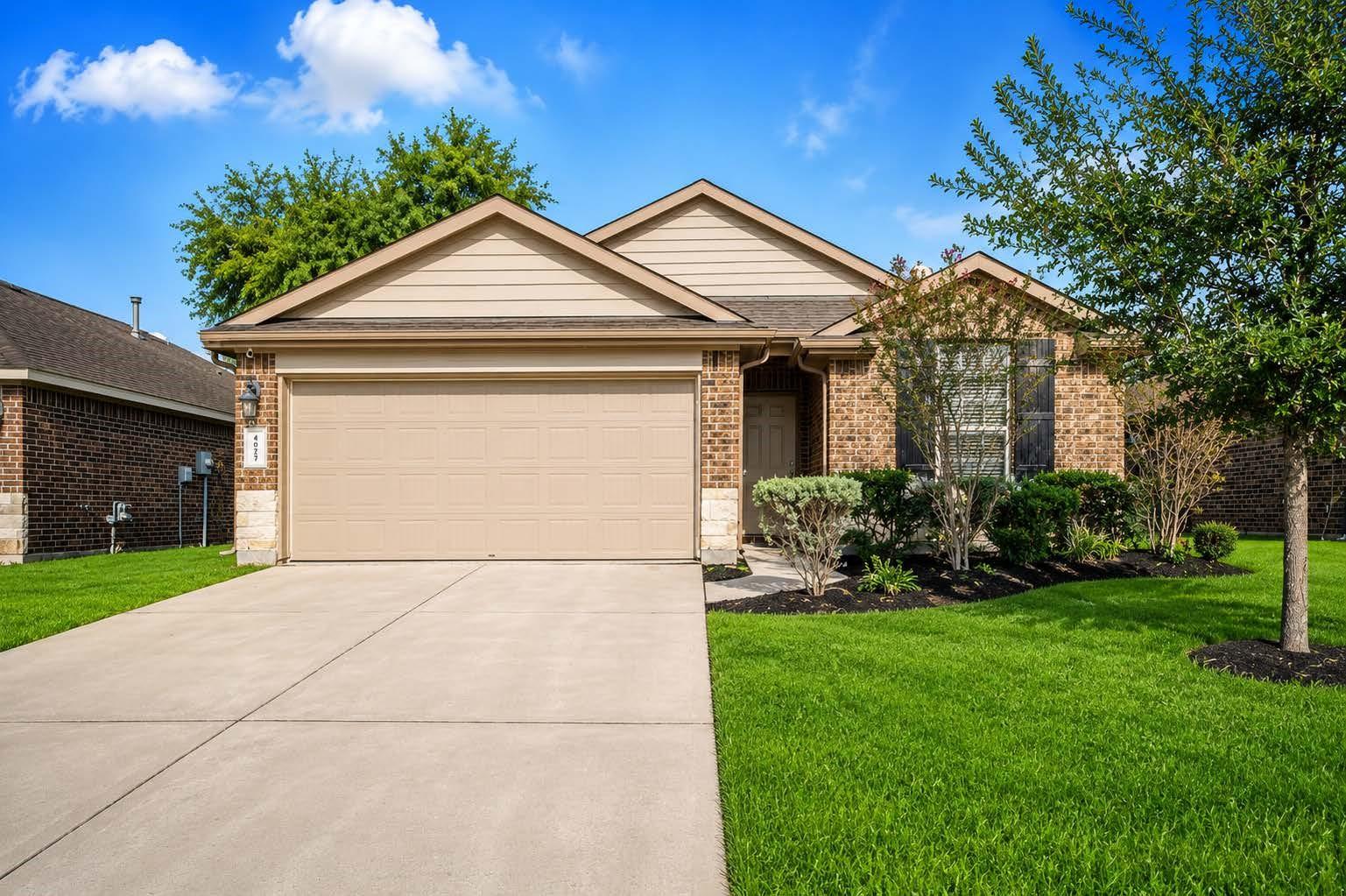 Image 1: This is a charming single-story brick home with a
