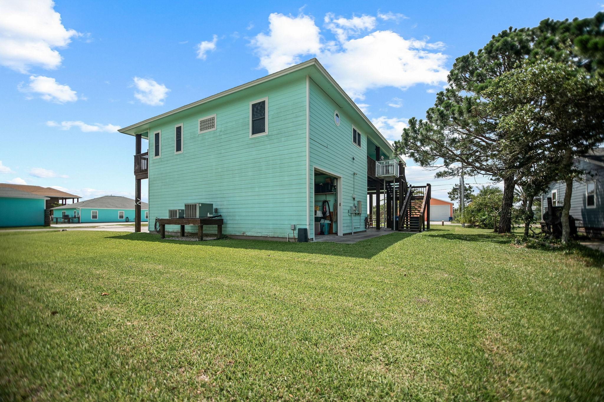 Image 4: Side/back side of home shows the large garage that