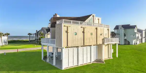Image 4: The rear exterior reveals the scale of the home an
