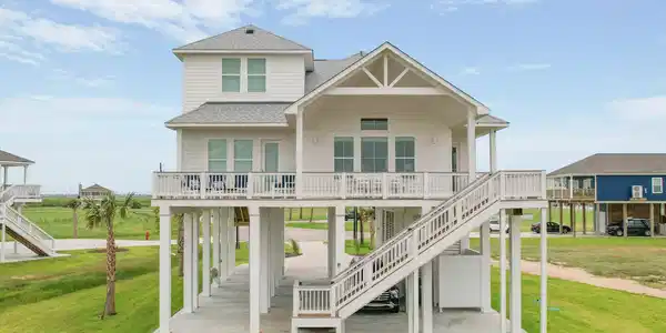 Image 2: Rear of home with balcony facing the sunsets of th