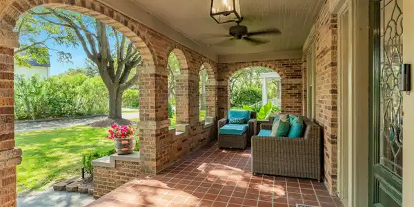 Image 4: Covered arched porch with tile flooring, ceiling f