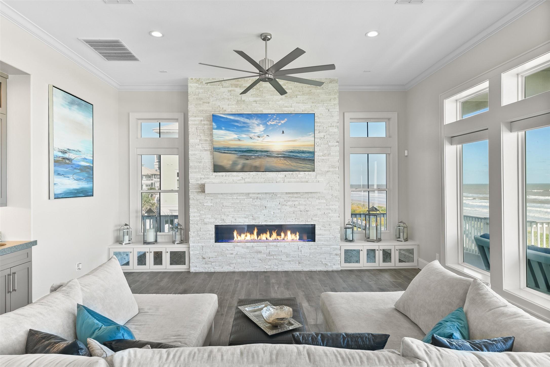 Image 2: This coastal living area is drenched in natural li