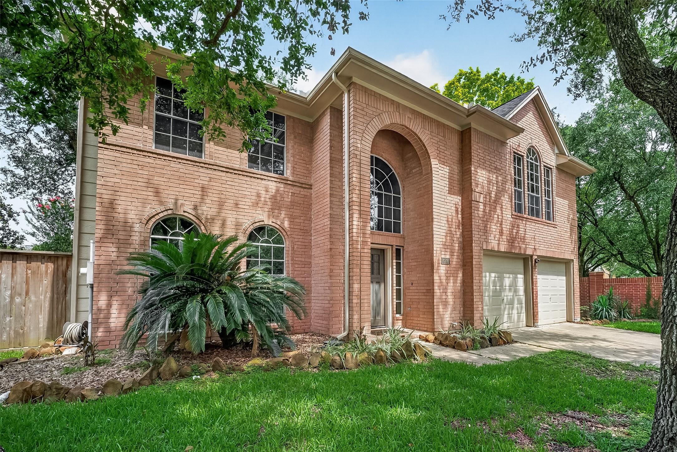 Image 2: BRICK FRONT ELEVATION AND YARD.