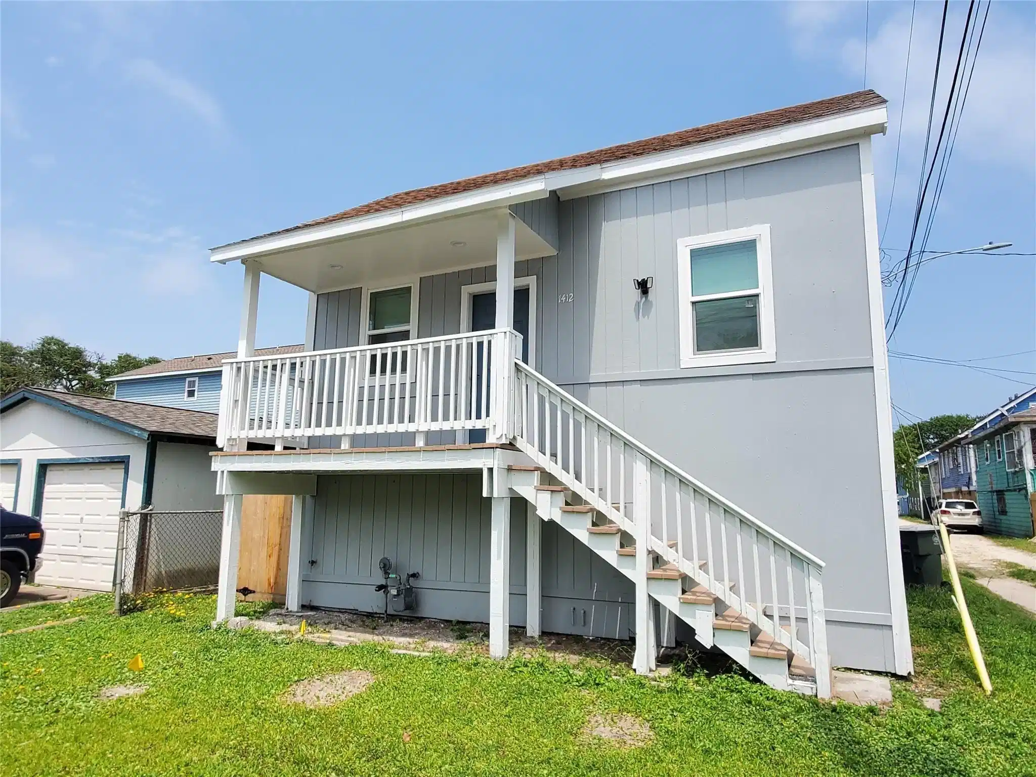 Image 1: This property features a two-story home with a rai