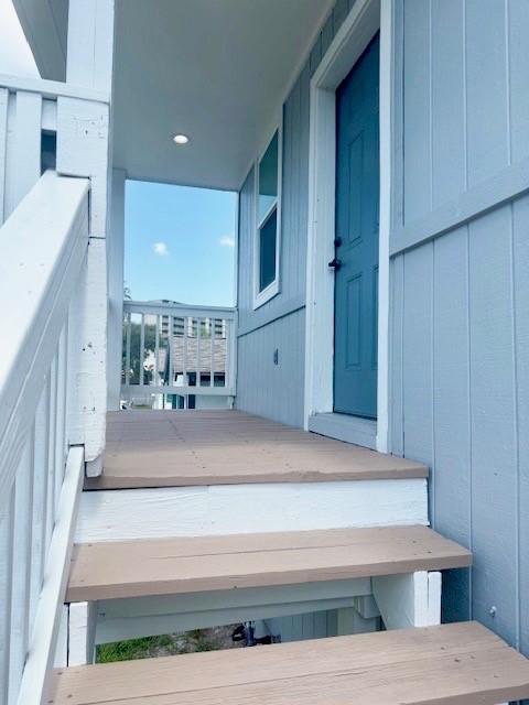 Image 3: Welcoming entryway with a light blue exterior and