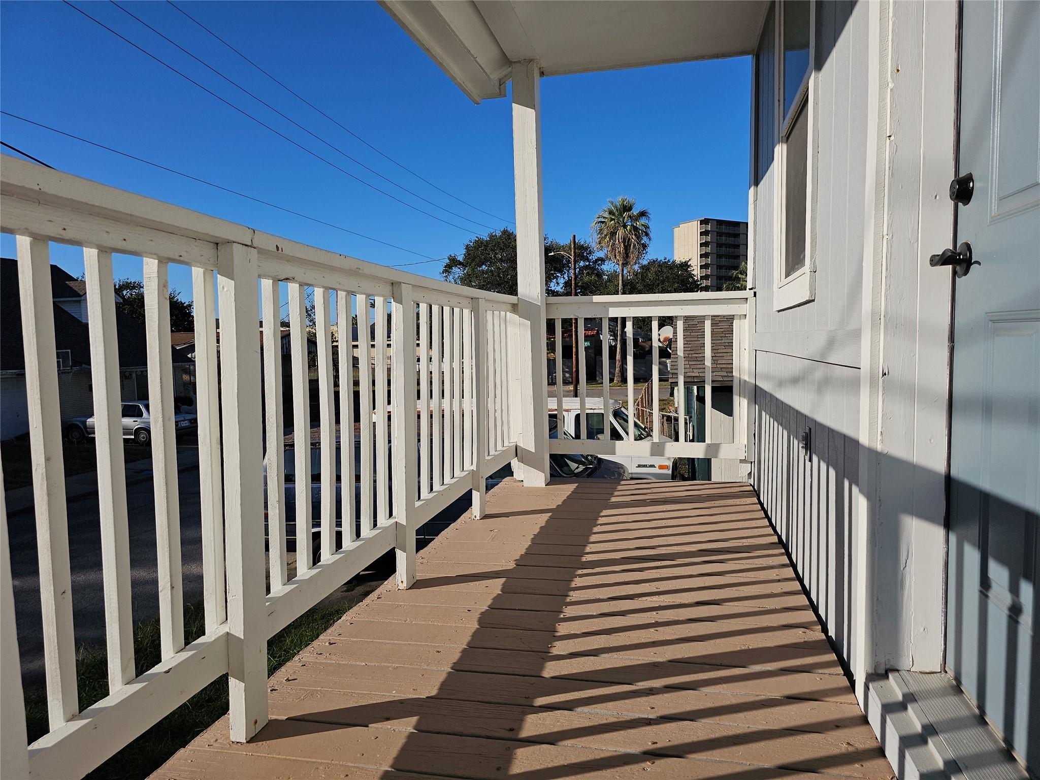 Image 4: This show has a cozy balcony with white railings a