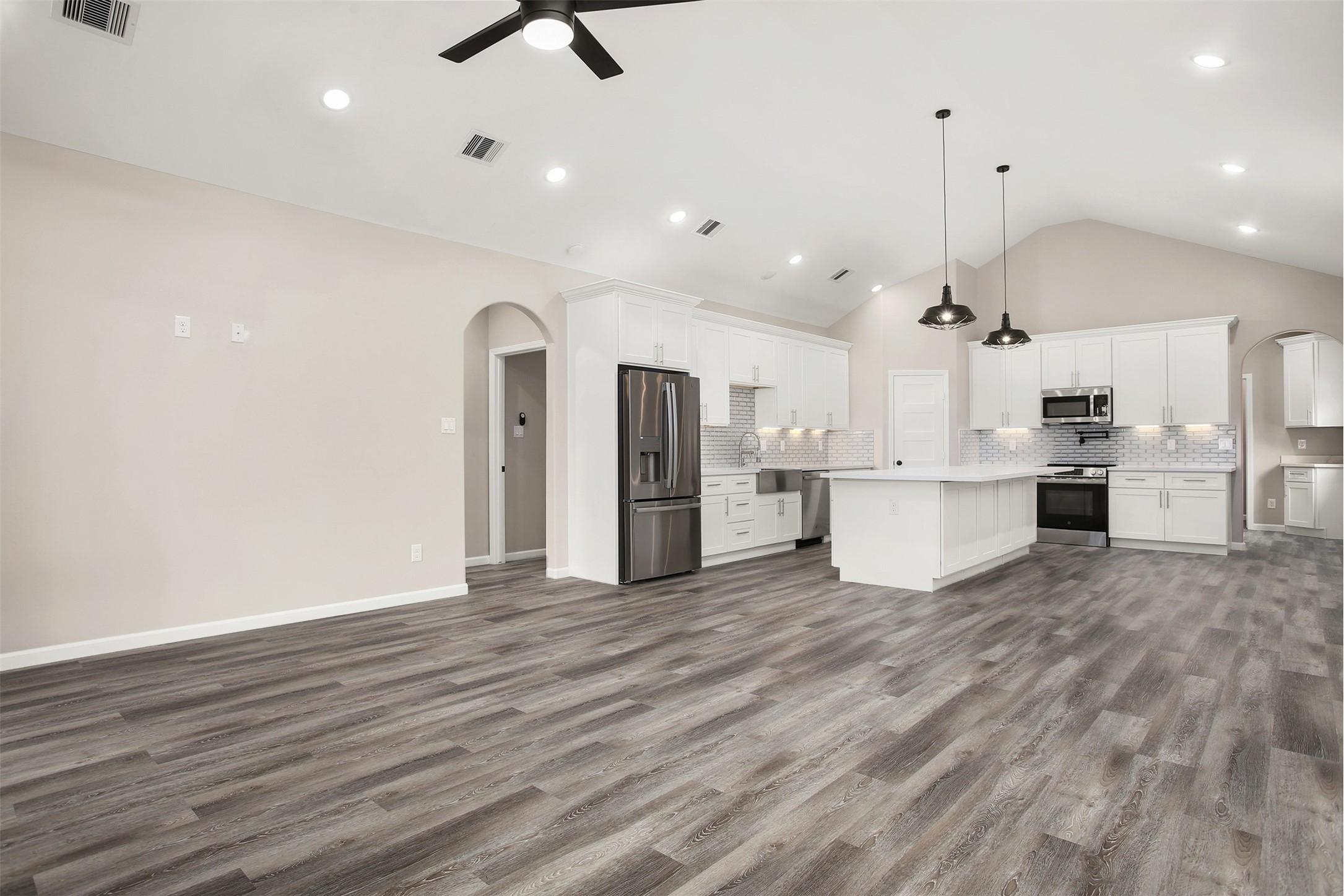 Image 3: Living room and kitchen with faulted ceiling
