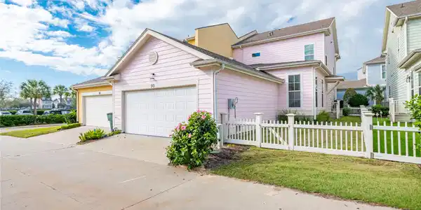 Image 2: It features a side yard with white picket fencing,