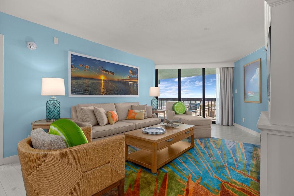Image 2: Bright, coastal-themed  living room with ocean vie