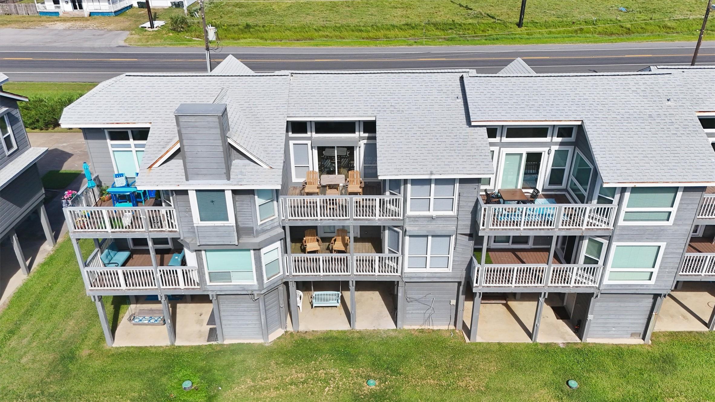 Image 2: The back of the townhome features multiple balconi