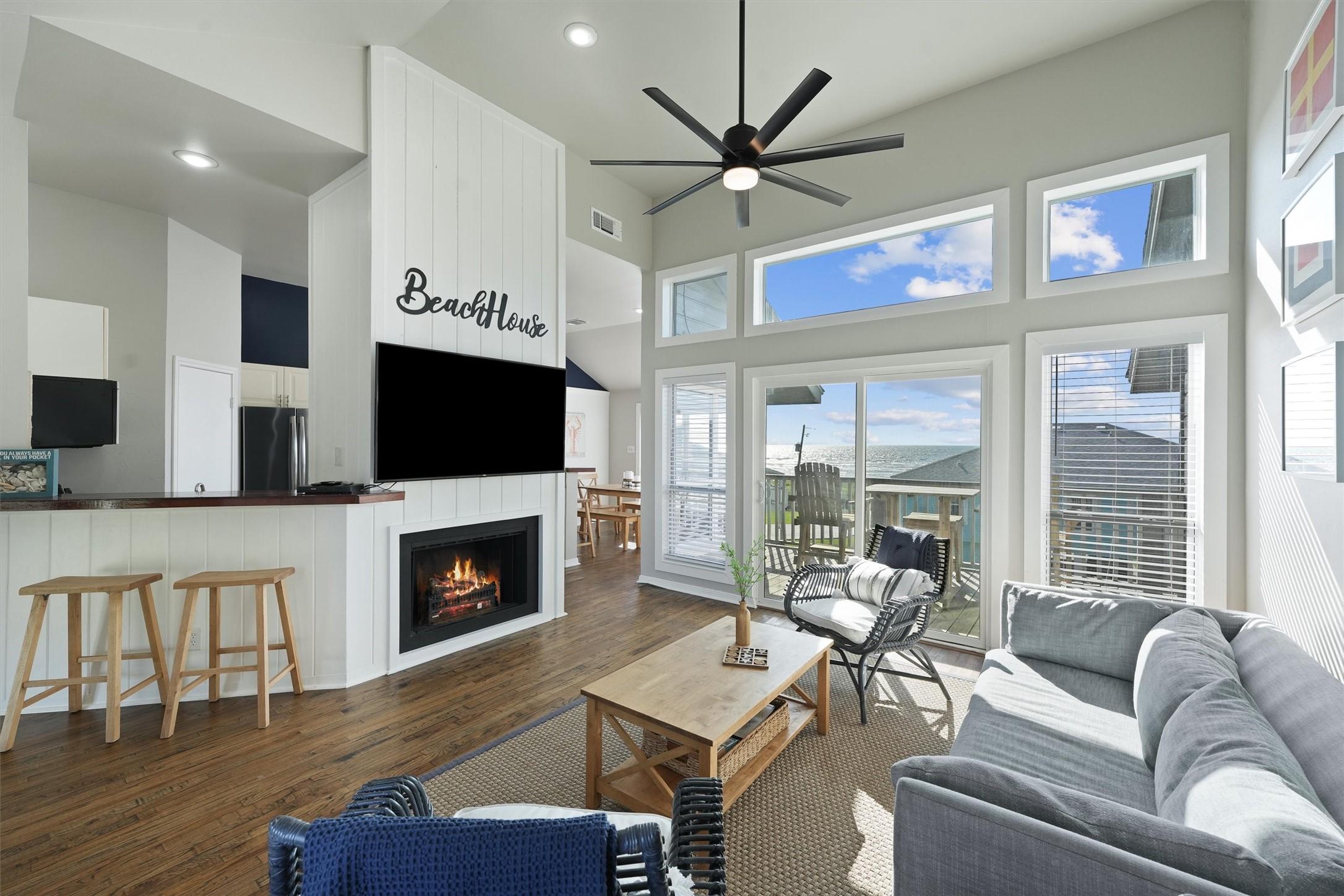 Image 3: The living room is bright and airy, featuring vaul